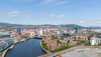 Fototapeta premium Aerial view on river and buildings in City center of Belfast Northern Ireland. Drone photo, high angle view of town