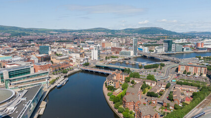 Fototapeta na wymiar Aerial view on river and buildings in City center of Belfast Northern Ireland. Drone photo, high angle view of town