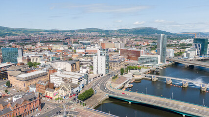 Obraz premium Aerial view on river and buildings in City center of Belfast Northern Ireland. Drone photo, high angle view of town