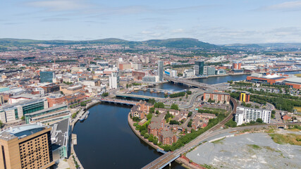 Obraz premium Aerial view on river and buildings in City center of Belfast Northern Ireland. Drone photo, high angle view of town