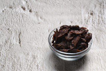 Jerky meat on a concrete background. Dried beef. Glassware. Copy space. Close-up. 