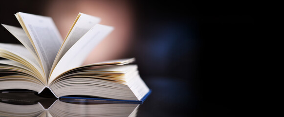 An open hardcover book lying on a table