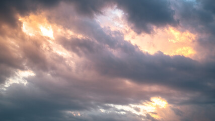 Sunset with heavy pink and orange clouds in the sky 
