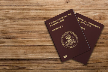 East Timorese passports are issued to citizens of East Timor to travel internationally. Passport on a wooden background