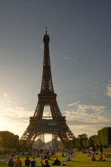 Naklejka premium tour Eiffel - couché de soleil admiré par des badauds