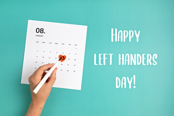 Text happy left handers day and calendar with heart in 13th of august over blue background - Powered by Adobe