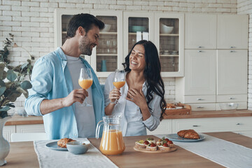 Beautiful young couple preparing breakfast together while spending time in the domestic kitchen