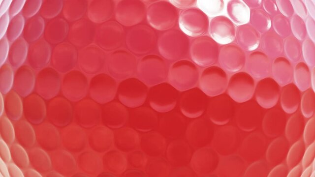 Realistic looping closeup view 3D animation of the spinning red golf ball rendered in UHD as motion background