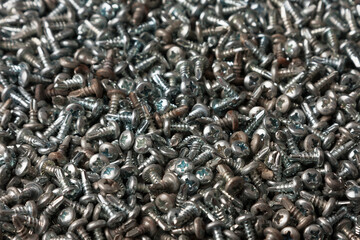 Tapping screws made of steel, metal screw, iron screw, wood screw. Screws as a background.