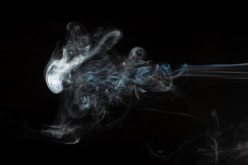 Abstract smoke isolated on black. White smoke on a black background.
