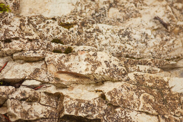 Stone wall texture, background, natural color. Fragment of a wall from a chipped stone.