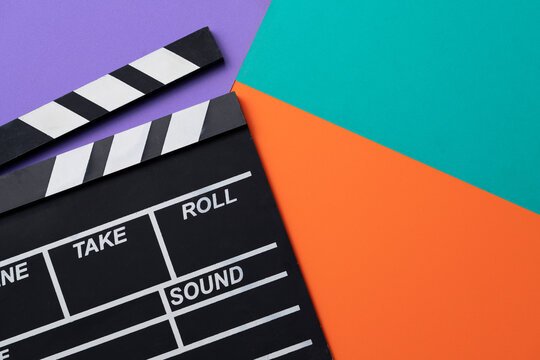 movie clapper on colorful table ; film, cinema and video photography concept