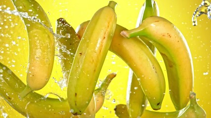 Super Slow Motion Shot of Flying Fresh Bananas and Water Side Splash at 1000 fps. - Powered by Adobe