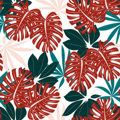 An original seamless tropical pattern with bright colorful plants and leaves on a delicate background. Trendy summer Hawaii print. Colorful stylish floral.
