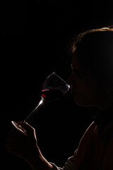 silhouette of a person drinking wine