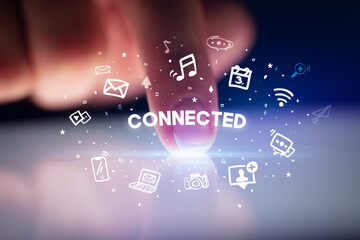 Finger touching tablet with social media icons concept