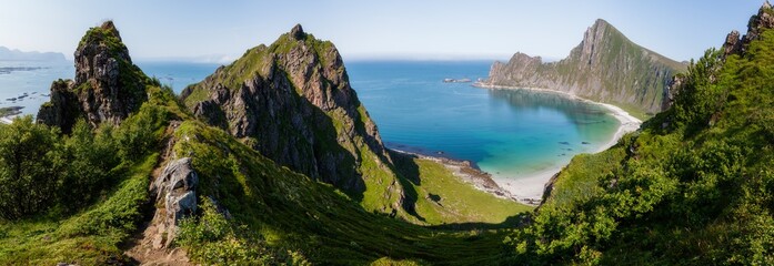 Stunning colorful fjord views.Wide summer panorama of a chain of rocky green mountain peaks encircling the shore of the fjord. Top view. Norway. Footpath to rock. - Powered by Adobe