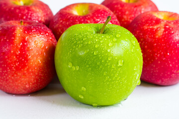  green apple and red apples with water drops