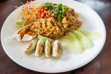 Fried rice with tom yum chili paste with eggplant, cucumber and salted egg.Thai food