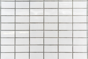 The white tiles on the walls are arranged in an orderly fashion.