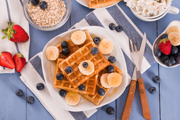 Waffles with blueberries, bananas and honey.