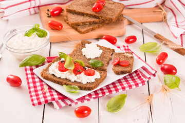 
Rye bread with cottage cheese, basil and tomato.

