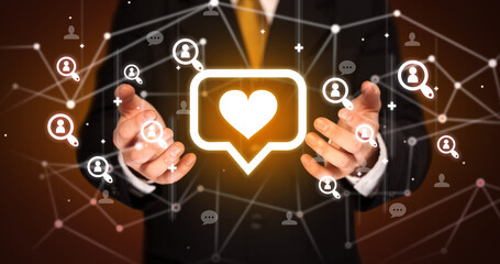 Hand holding social media icons