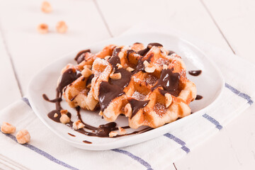 Waffles with chocolate cream and hazelnuts.