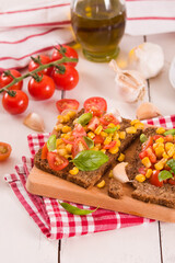 Rye bread withsweet corn, basil and tomato.