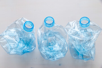 Crushed or crumpled clear plastic bottles. Plastic waste. Plastic recycling. Plastic pollution and...