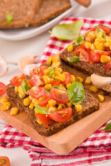 Rye bread withsweet corn, basil and tomato.