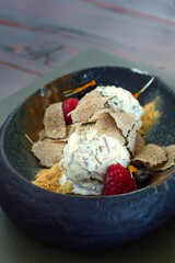 Homemade vanilla ice cream with fruits and sliced truffle mushrooms in Motovun, Istria