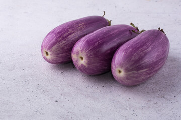 eggplant or brinjal, vegetables on a white surface, closeup