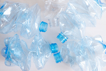 Crushed or crumpled clear plastic bottles. Plastic waste. Plastic recycling. Plastic pollution and waste management. 