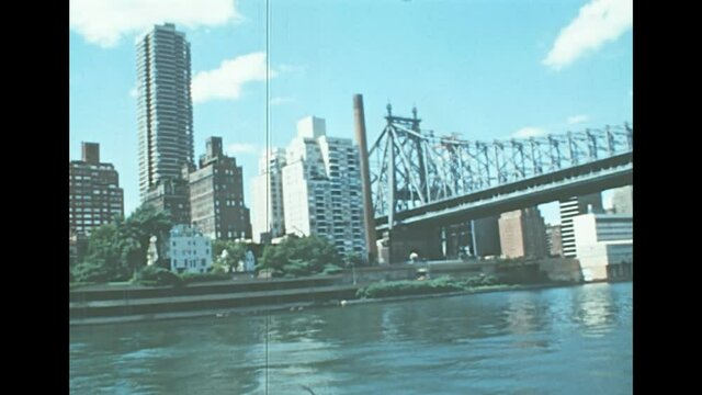 Archival of Long Island skyline by sea view from East river sightseeing cruise in New York. Old house buildings of the old New York city. United States of America in 1976. Vintage USA from 70s.