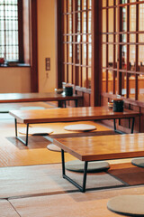 Traditional japanese machiya house or ryokan restaurant with wooden table and doors with natural bright light