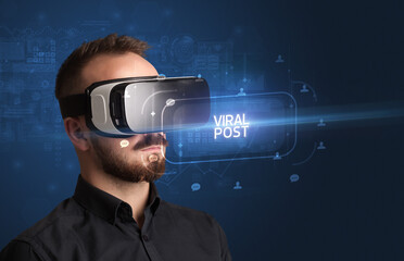 Businessman looking through Virtual Reality glasses, social media concept