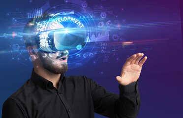 Businessman looking through VR glasses