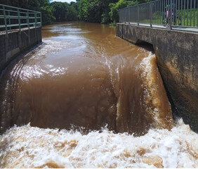 Brown muddy water of Erft river in a weir in Grevenbroich in Germany