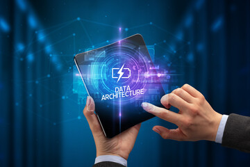 Fototapeta premium Businessman holding a foldable smartphone, technology concept