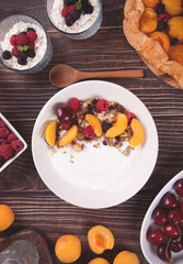 cottage cheese and yougurt with granola, berries and fruits apricot for healthy breakfast.