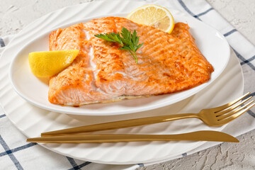 grilled salmon fillet on a white platter