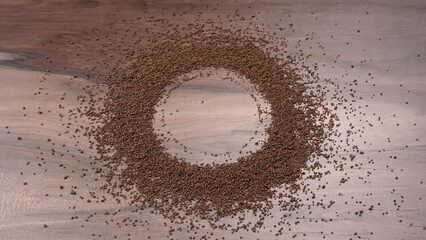 Black Tea Powder or dry dust tea powder, chai patti isolated in wooden bowl with Cardamom, Clove...