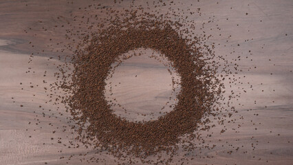 Black Tea Powder or dry dust tea powder, chai patti isolated in wooden bowl with Cardamom, Clove...