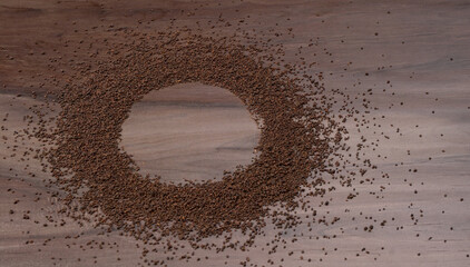 Black Tea Powder or dry dust tea powder, chai patti isolated in wooden bowl with Cardamom, Clove...