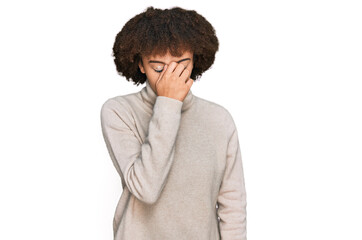 Young hispanic girl wearing wool winter sweater tired rubbing nose and eyes feeling fatigue and headache. stress and frustration concept.