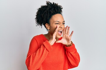 Young african american girl wearing casual clothes shouting angry out loud with hands over mouth