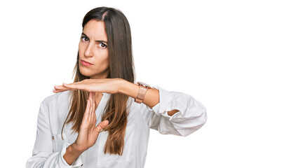 Young beautiful woman wearing casual clothes doing time out gesture with hands, frustrated and...
