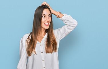 Fototapeta premium Young beautiful woman wearing casual clothes smiling confident touching hair with hand up gesture, posing attractive and fashionable