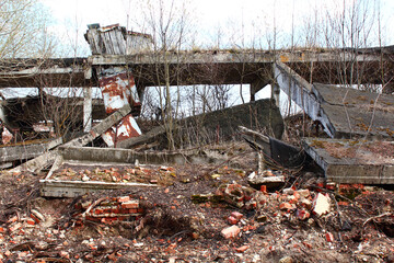 Destroyed abandoned hangar ruins. Farm building destroyed by weather after economic crisis.